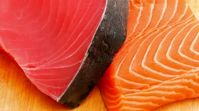 stock-footage-fresh-raw-salmon-and-red-tuna-fish-pieces-over-wooden-board-shallow-dof-x-intro-motion