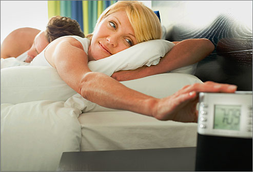 getty_rf_photo_of_woman_turning_off_alarm_clock