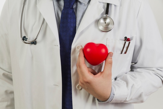 medico segurando um coração de borracha