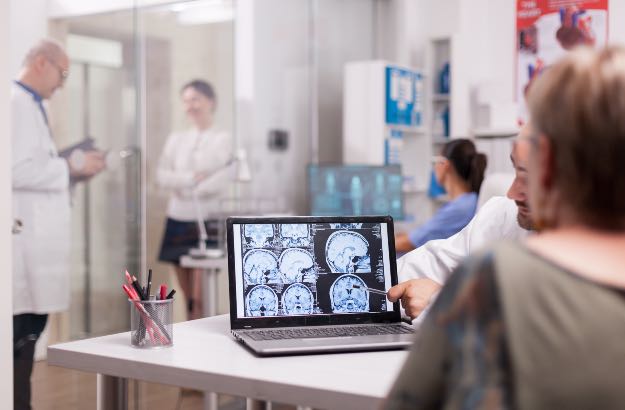 Médico neurologista explicando para paciente resultados dos estudos clínicos 