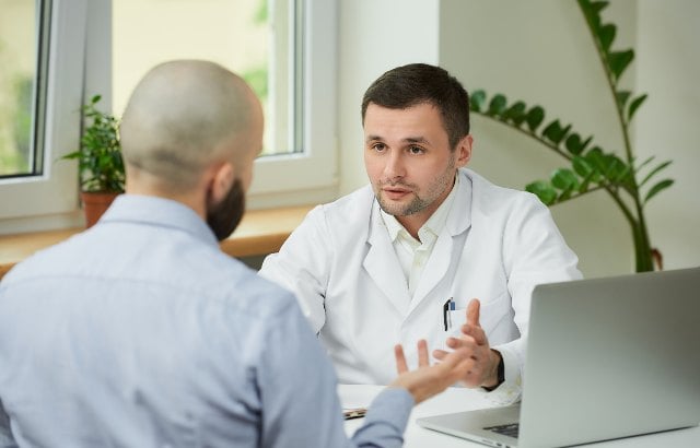 Paciente na clínica conversando com médico sobre canelite 